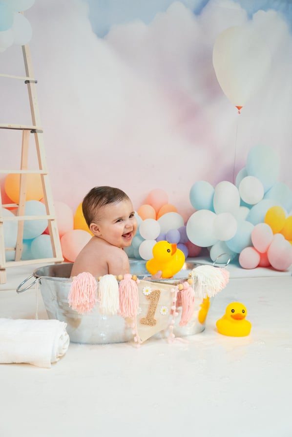 a baby in a tubtub with a rubber duck in it