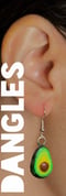 a woman wearing a green avocado earrings