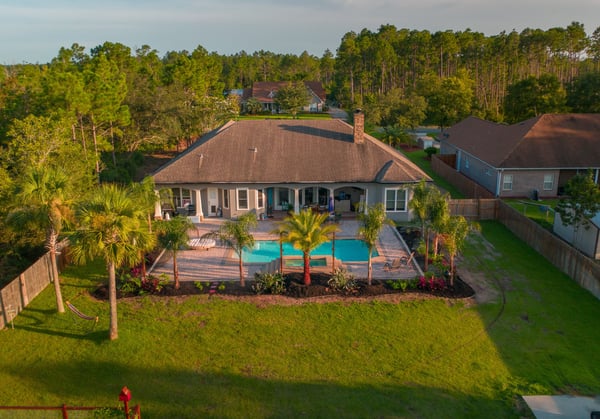 Finished coastal landscape with lush tropical plants and clean beds