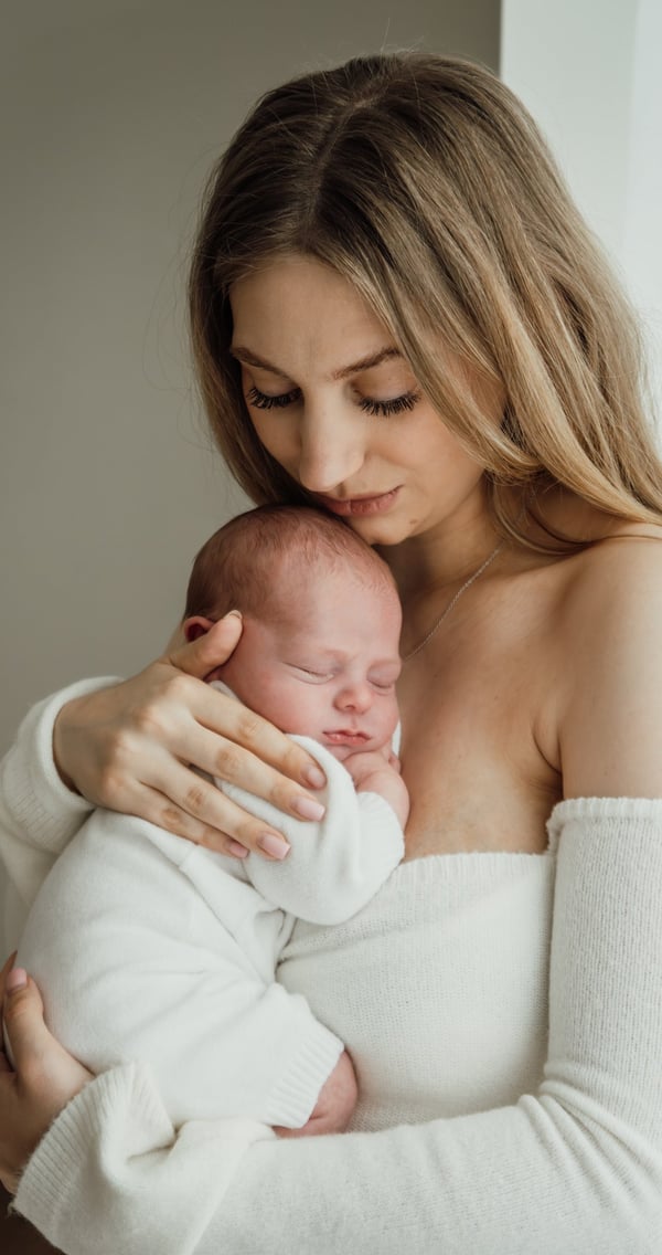 a woman holding a baby in her arms