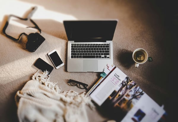 a laptop computer sitting on a carpeted floor