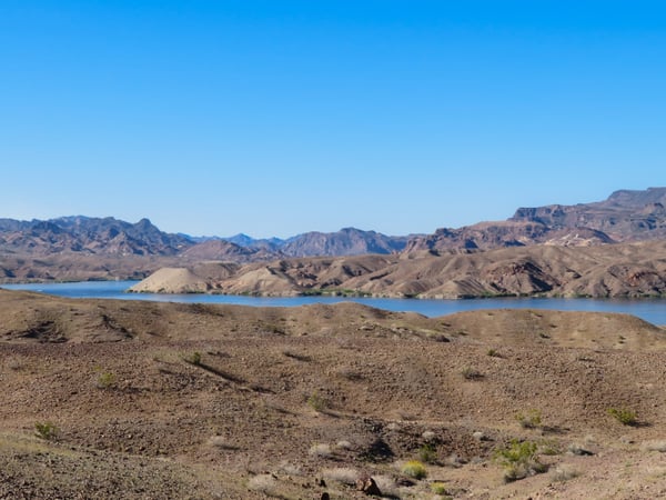 Colorado river winding through the desert in the distance with desert and mountains