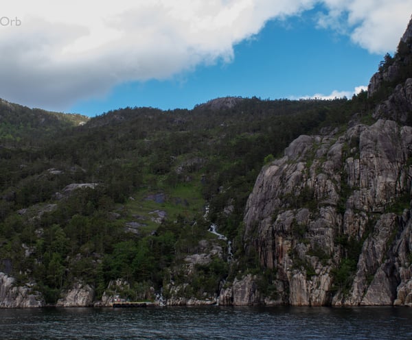 small waterfall at the side of the fjord
