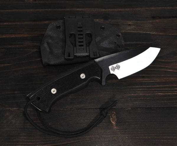 a baltic blades SERE knife - cut knife and a knife on a wooden table