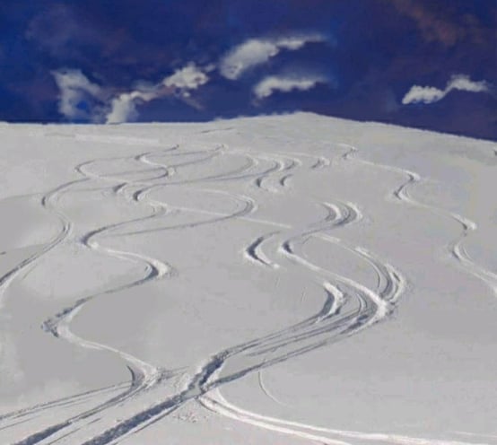 Skiing the powder with S-turns.
