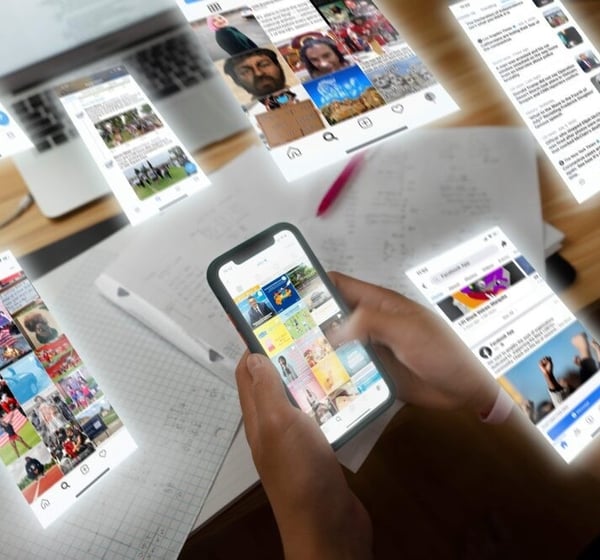 image of a person holding a phone looking at social media
