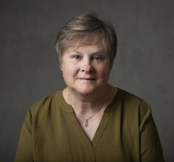 Portrait of an olser woman in sage green