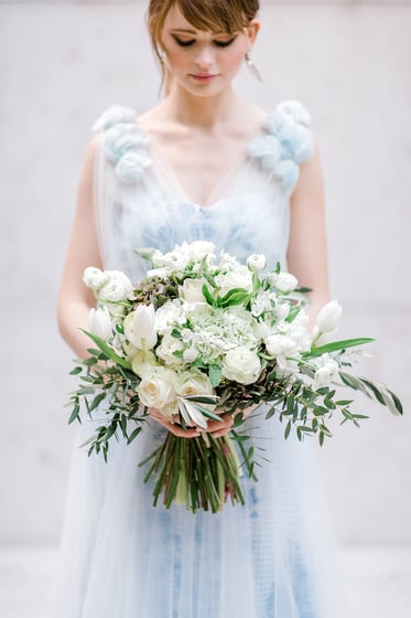 Beautiful bride in Karen Rodrigues gown holding flower bouquet