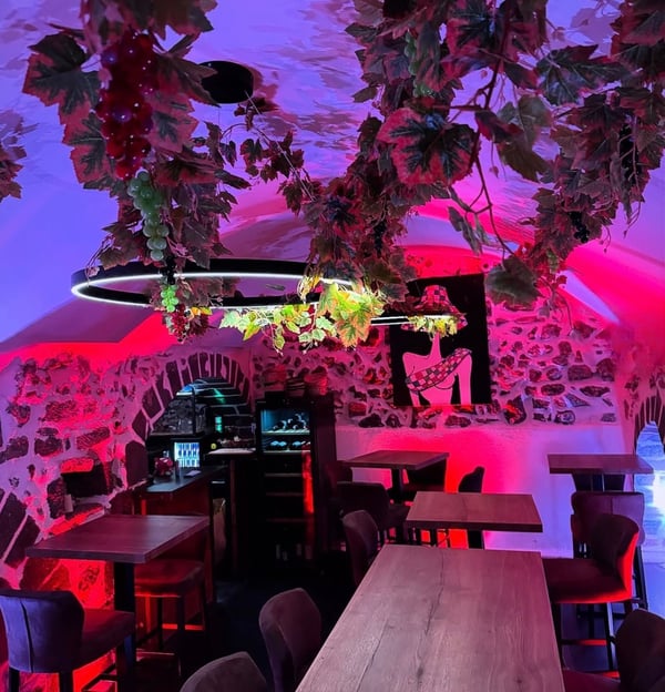 a restaurant with a large table and chairs