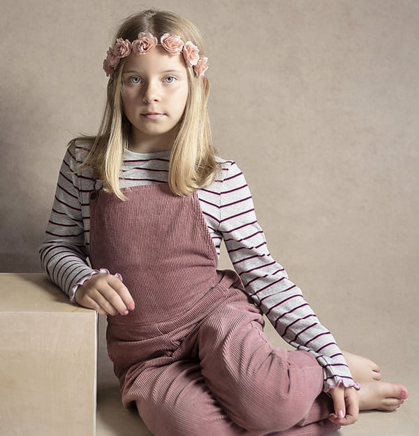 Young girl with pink dungerees
