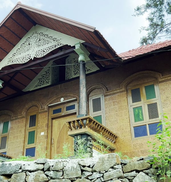 a house with a stone wall and a stone wall