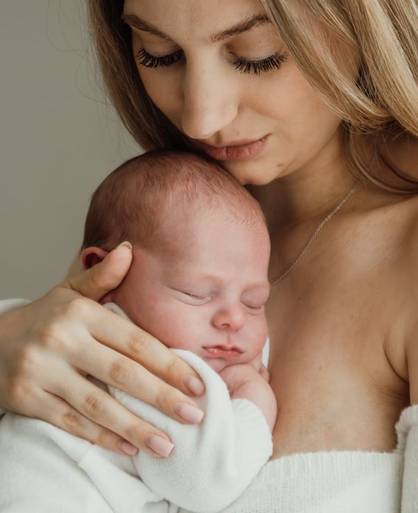 a woman holding a baby in her arms