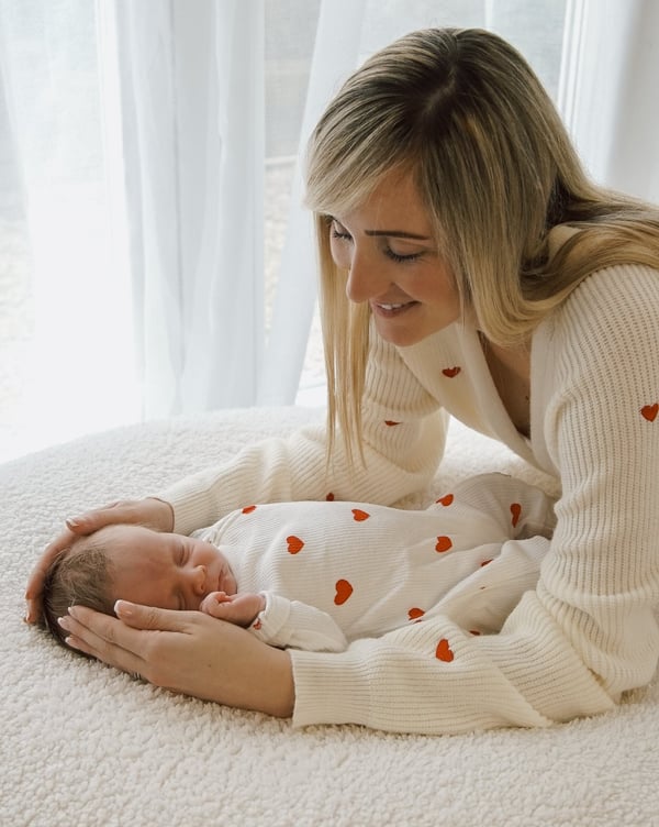 a woman holding a baby in her arms