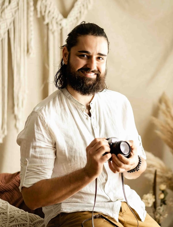 Thomas, fine art elopement photographer in Provence, smiling with camera in hand