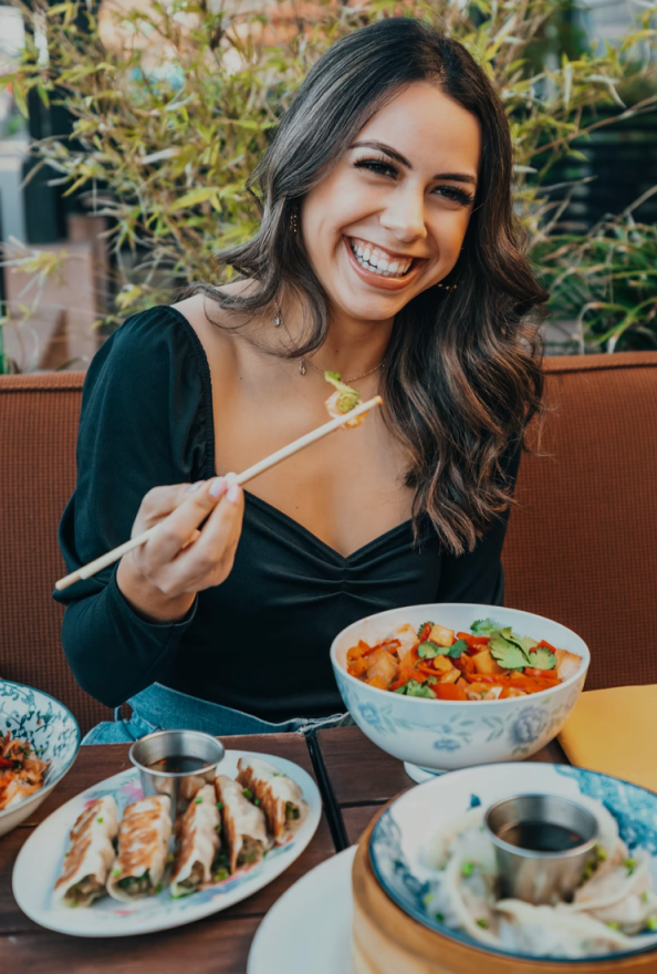 a woman is eating a meal at a restaurant