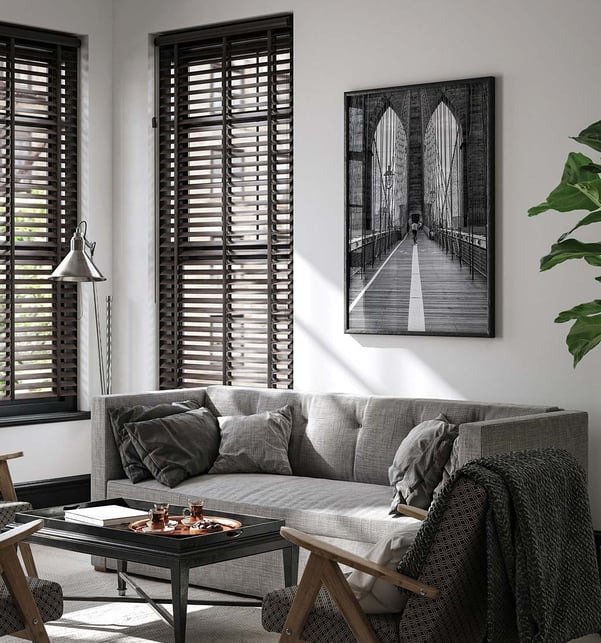 Black and white architectural photograph displayed above a modern sofa