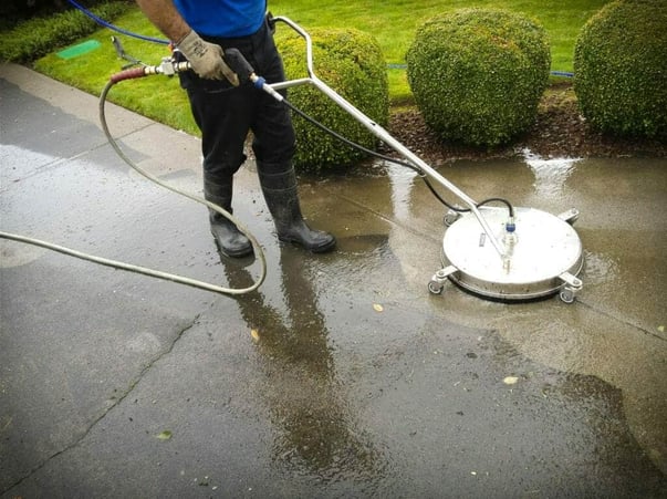 Surface cleaning concrete during pressure washing services