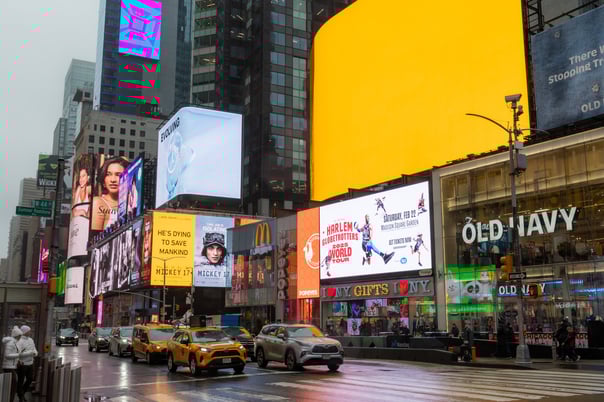 bright colours of Times Square, a queue of traffic waiting to pass by.