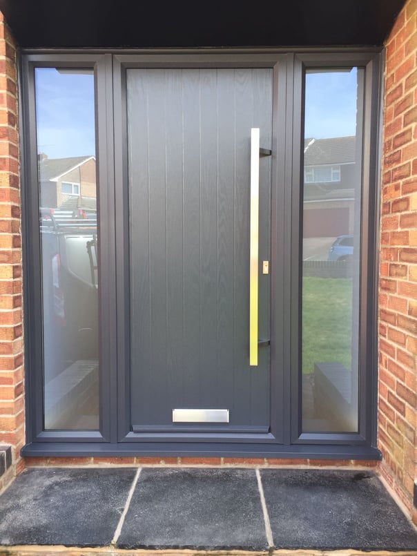 modern grey composite door with no glass.  Ral 7016 coloured frame.  2 side panels 