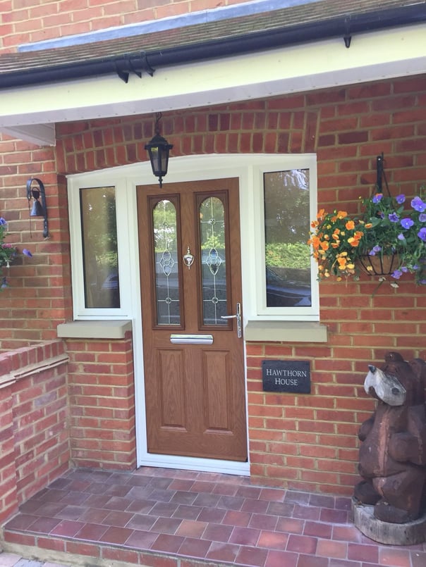 oak wood colour composite door with decorative glass and half glazed side panels 