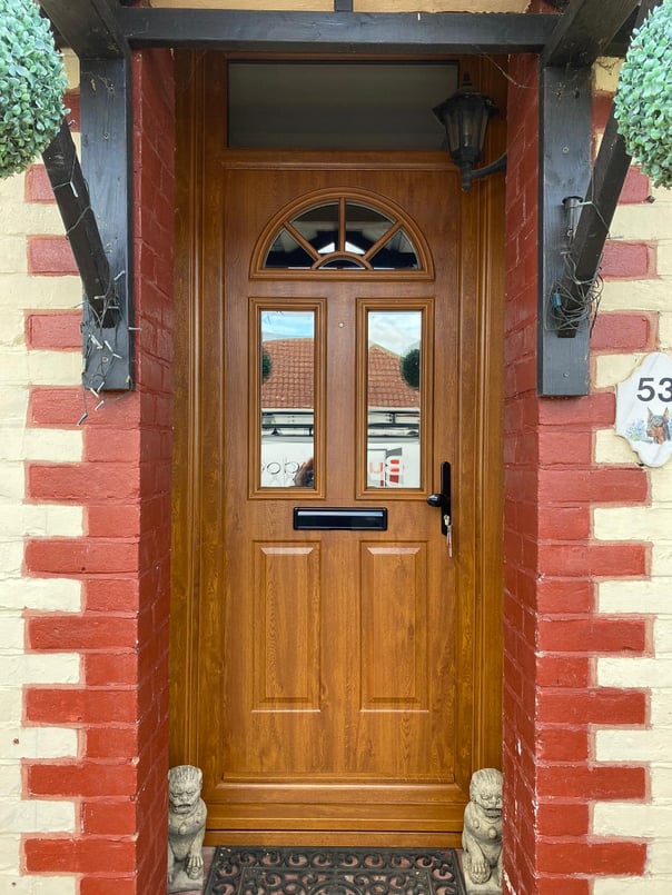 wood coloured new composite front door fitted in Hampshire