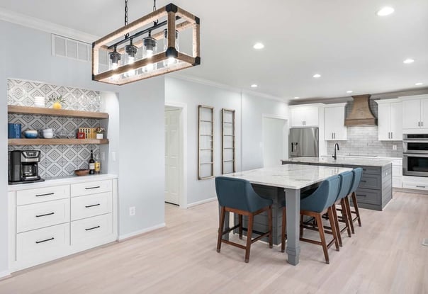 a kitchen with a marble counter top and a bar stool