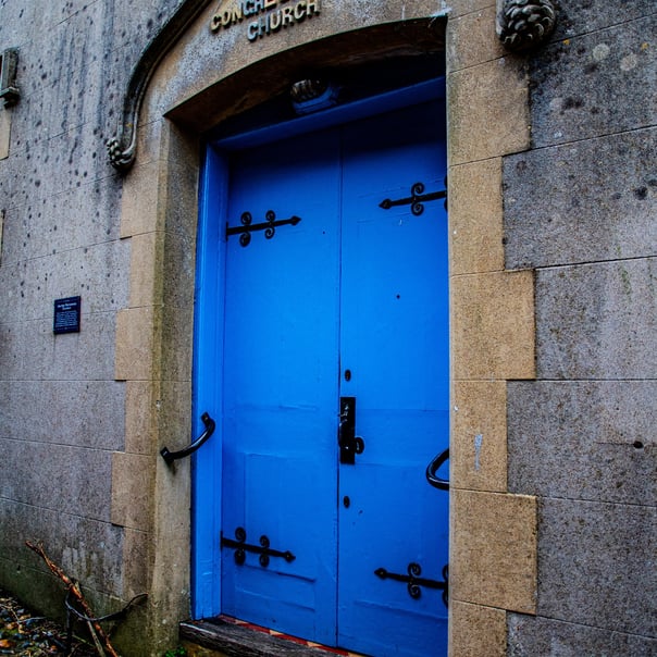 a photo of a bright blue door surronded in stone. Written above the door are the words "1801 Congregational Church"