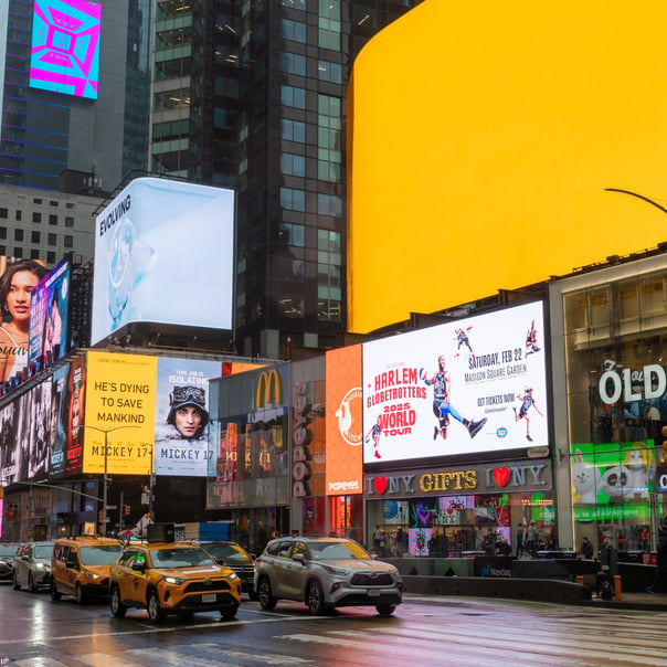 bright colours of Times Square, a queue of traffic waiting to pass by.