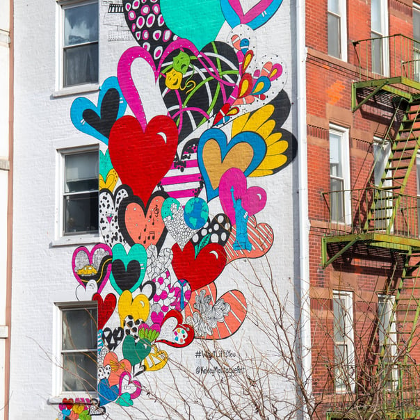 Beautiful colourful heart art work bubbling up th eside of an apartment building in Hudson Years, New York.