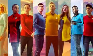 eight people standing next to one another from Star Trek crew