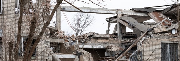 The image shows the remains of a severely damaged building