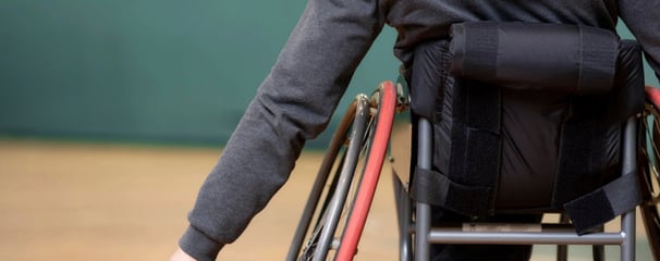 Child with muscular dystrophy receiving physiotherapy for strength and mobility.