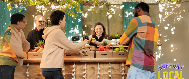 Customers buying fresh produce from a friendly vendor at a farmers' market, supporting local farmers