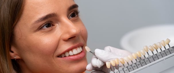 a woman in a dental care center with a smile on her face