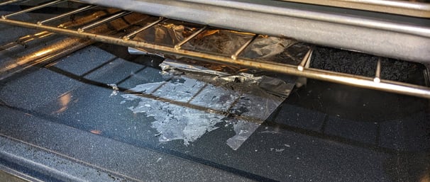 Burnt aluminum folio inside a stove