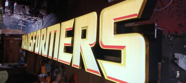 a large iluminated sign of transformers
