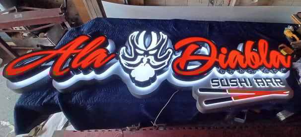a sign for a sushi bar that says Ala Diabla