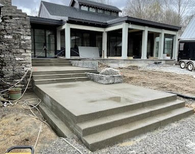 a house with a concrete patio and stairs