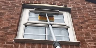 window on the outside of a house being cleaned  by keystone property care