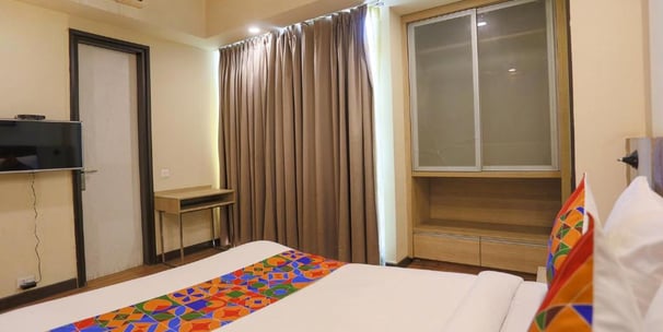 a bed room with a television and a television