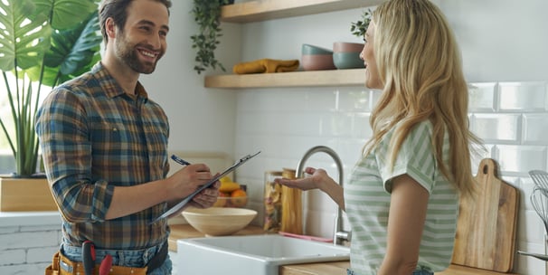 Homeowner and contractor reviewing kitchen renovation plans during a consultation in London, Ontario
