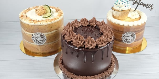 three cakes with chocolate frosting and frosting on them