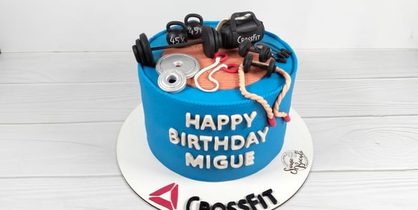 a cake with a gym themed cake topper