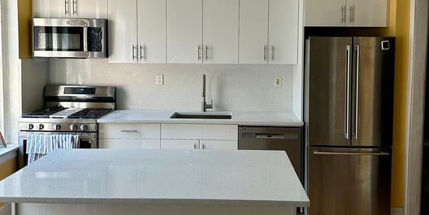 a kitchen with a stainless steel refrigerator and a refrigerator
