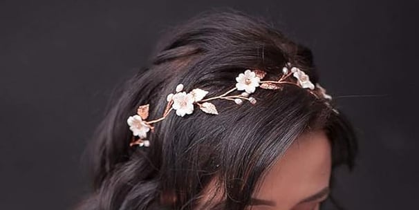 a woman wearing a white dress and a flower crown