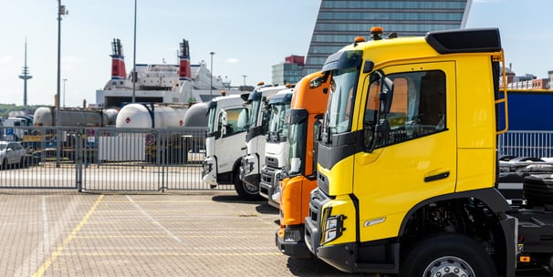 a truck parked in a parking lot with a large truck