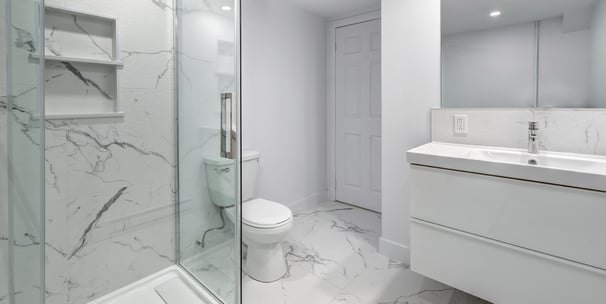 Luxury glass shower with marble tile and modern vanity in bathroom renovation in London, Ontario.