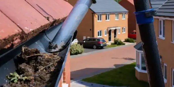 leaves being removed from gutter in worcestershire