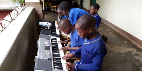 Tanzanian villange children are learning music on keyboards