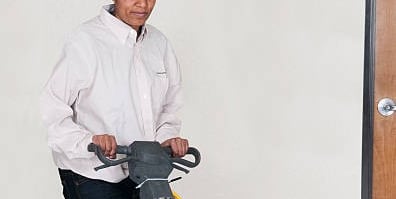 a woman is cleaning a floor with a floor cleaning machine